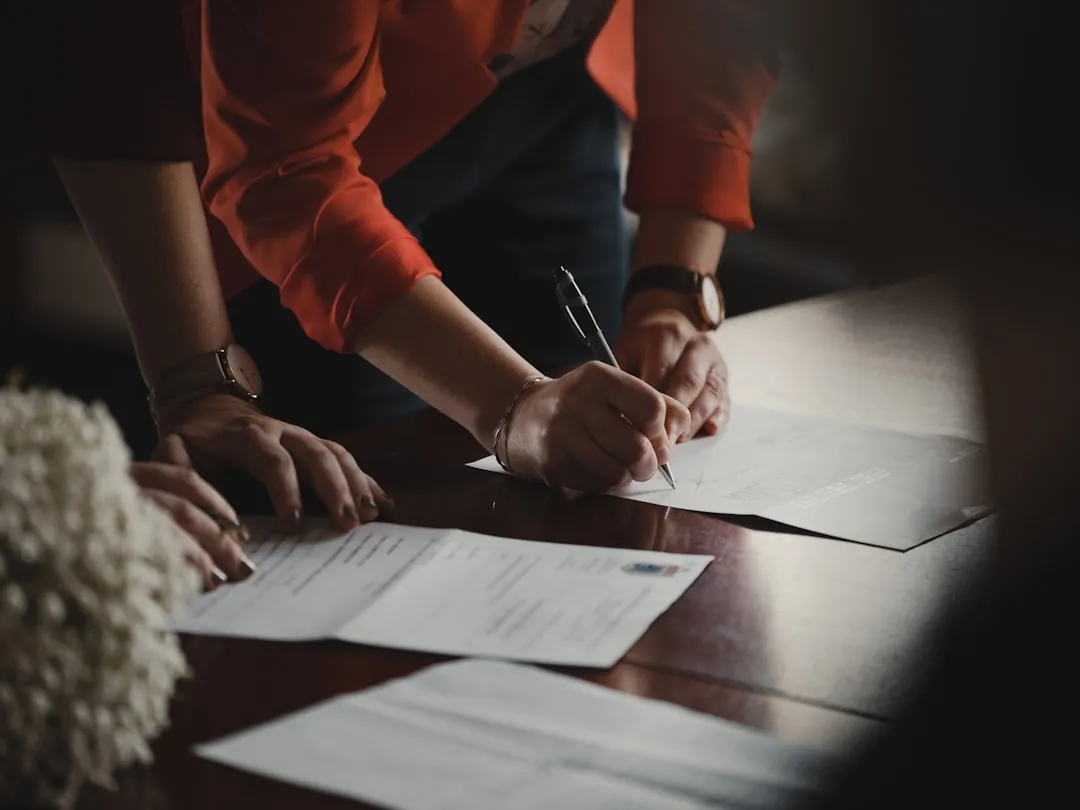 professionals reviewing documents in meeting, due diligence
